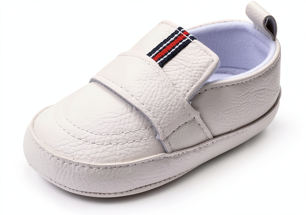 Baby boy wearing soft white PU leather shoes during a family gathering